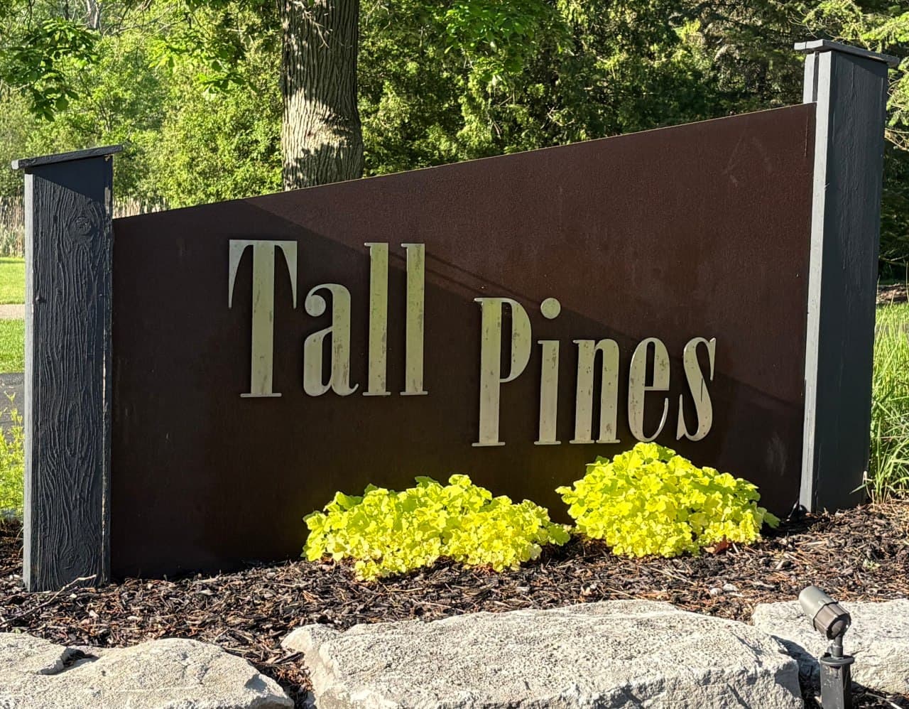 Community entrance sign for Tall Pines